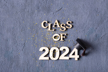 Class of 2024 concept. Number 2024 with graduated cap and confetti