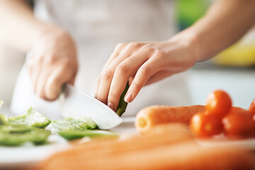 Cooking, hands and knife for vegetables on kitchen counter in home for diet, health or nutrition....