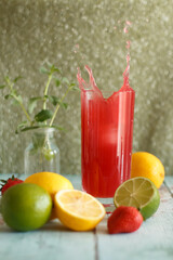 Strawberry juice with splash and with ice cubes.