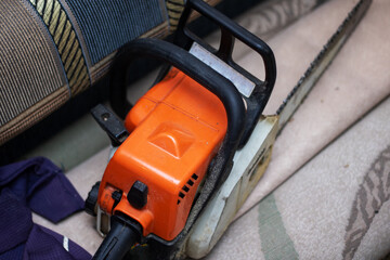 Chainsaw rests on hardwood flooring, a powerful gas machine