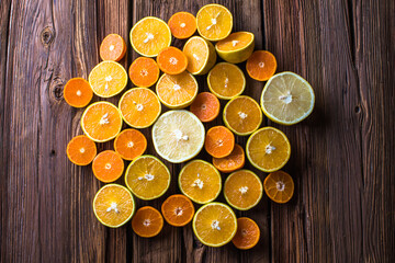 Orange fruit slices, half orange on wooden background