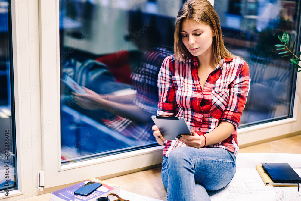 Poster creative female designer updating content in flog via tablet editing photos using technology before 