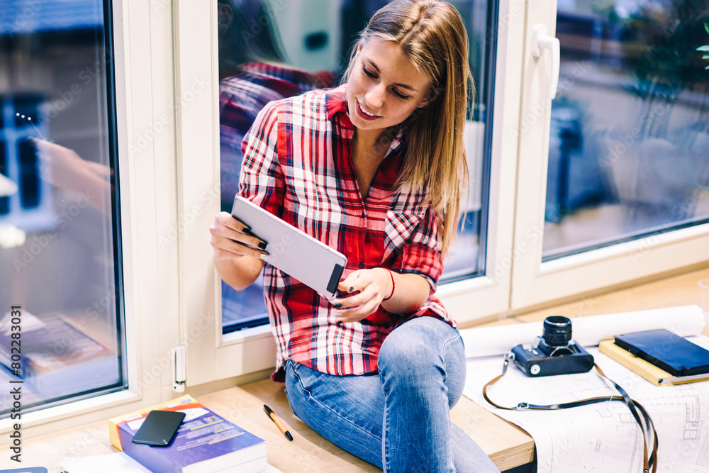Poster young female student using portable pc for playing online games on break during preparing homework t