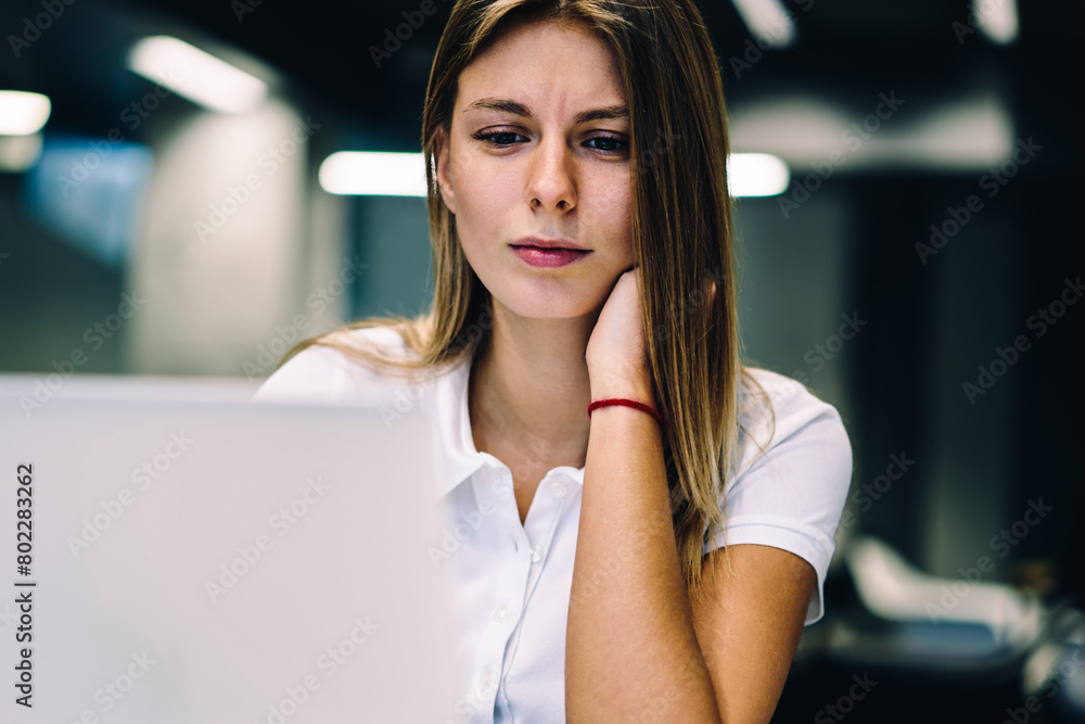 Poster pensive female student watching tutorial concentrated on analyzing information for e-learning on cou