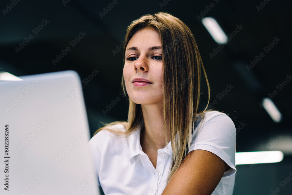 Poster skilled female freelancer updating content on website working online via laptop computer and wifi co