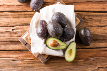 Many Avocado. Cut avocado on a oak wood background table.