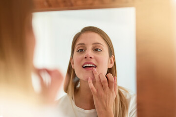 Woman, home and mirror with applying lipgloss for beauty, reflection and confident with results. Female person, face and lipstick for aesthetics, cosmetics and transformation for self care and love