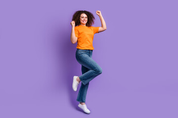 Photo of cheerful positive glad woman wear trendy clothes raised hands celebrate success isolated on purple color background