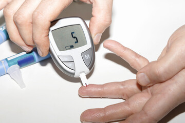 Diabetic man measuring blood sugar level. Blood test for diabetes.