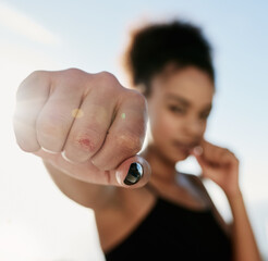 Fototapeta premium Black woman, boxer and hand to punch for fitness in outdoor for workout or training with health or wellness as fighter. Active, female person and exercise with fist for speed as warrior by house