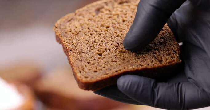 a loaf of rye black bread made from rye and wheat flour, a square dark loaf of bread on the table