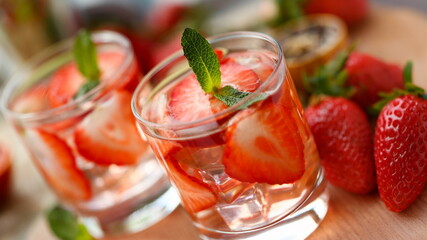 Strawberry punch home made cocktail closeup on wood background