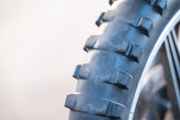 Worn tires on Enduro motorcycle, close up, copy space on the left. Care and renovation of the...