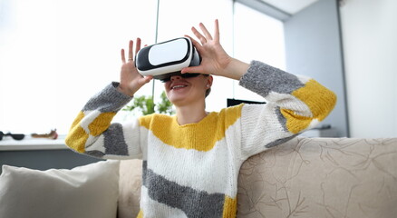 Beautyful woman sit at sofa with vr glasses portrait. Online distance education concept