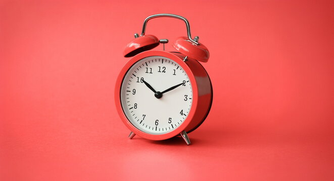 Coral old alarm clock on red background concept