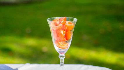 Cut up tomatoes in a glass