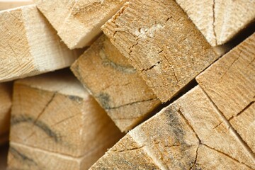 A close-up shot of a stack of wooden beams.