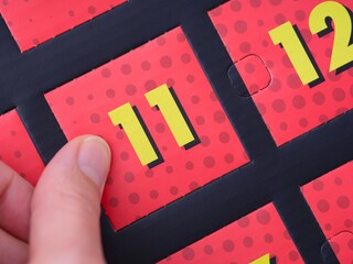 A woman hand ready to open the door with number 11 on the advent calendar. - obrazy, fototapety, plakaty