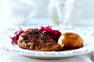 Fried pork ribs with potato dumplings on bright background. Close up.