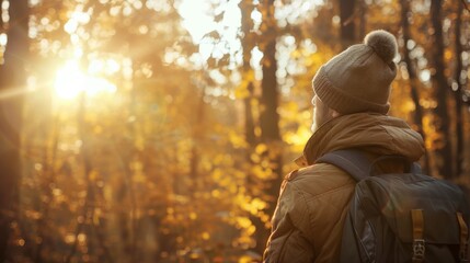 Fototapeta premium A Solitary Hiker in Autumn Forest