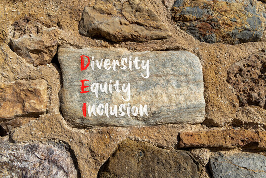 DEI diversity equity and inclusion symbol. Concept words DEI diversity equity inclusion on big stone. Beautiful stone wall background. Business DEI diversity equity and inclusion concept. Copy space.