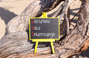 EDI electronic data interchange symbol. Concept words EDI electronic data interchange on blackboard. Beautiful old tree background. Business and EDI electronic data interchange concept. Copy space.