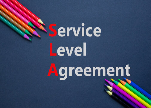 SLA service level agreement symbol. Concept words SLA service level agreement on black paper. Beautiful black background. Colored pencils. Business SLA service level agreement concept. Copy space.