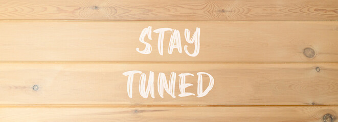 Stay tuned symbol. Concept words Stay tuned on beautiful wooden wall. Beautiful wooden wall...