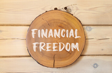 Financial freedom symbol. Concept words Financial freedom on beautiful wooden circle. Beautiful...