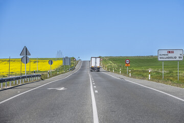 A cargo truck driving on a highway with a maximum speed limited to 90 kilometers per hour