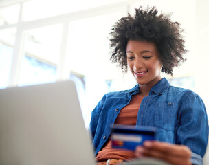 Credit card, laptop and online shopping with afro black woman in home for payment or purchase....
