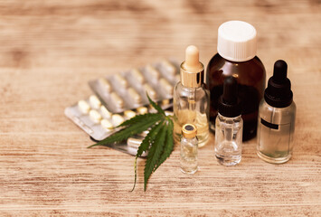 Mockups of medicines on a beige background with cannabis leaves. Layouts of a medicine bottle and a...