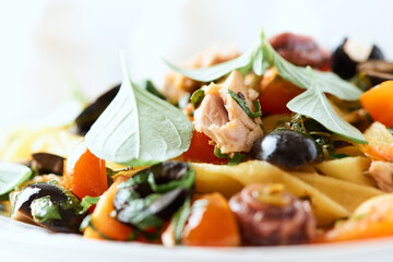 Pappardelle Pasta with cherry tomatoes, red onion and fresh basil on white wooden background.	