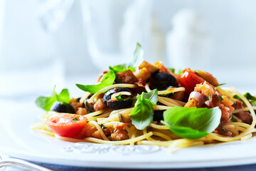 Spaghetti Pasta with Vegetables and fresh Basil on bright wooden Background.