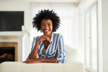 Portrait, black woman and couch in home for relax, calm or living room on break. Face, smile or...