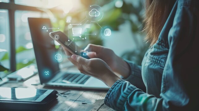 A businesswoman is using her phone to access a mobile app. The app has a variety of features, including the ability to track her spending, set budgets, and manage her investments. The woman is happy w