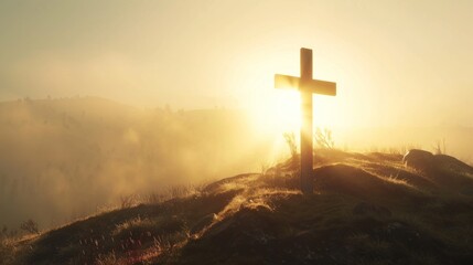 cross on top of mountain with fog and sunlight