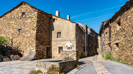 Water fountain in mountain village with stone houses, black villages, Spain.