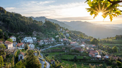 Morning sunrise view on Ermida do Gerês village from Miradouro da Ermida with sunstar, Parque...