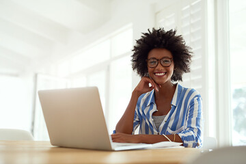 Portrait, black woman and laptop in home with glasses for remote work, online business and...