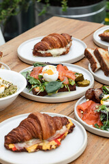 Delicious Alfresco Breakfast Setting with Croissants and Fresh Salads