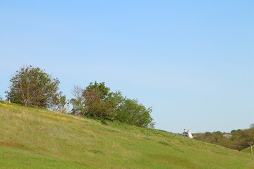 A couple people walking on a hill