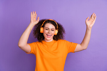 Photo of funky carefree lady dressed orange t-shirt having fun enjoying music headphones isolated violet color background