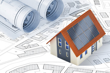 Photovoltaic system installation on a residential building - Building permit concept with home model and imaginary cadastral map
