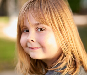 Portrait, girl and happiness in garden for spring, smile and sunshine in park on weekend. Female child, pride and confident in backyard for vacation, break and nature for development or gardening