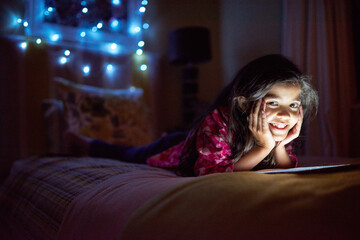 Night, smile and tablet with portrait of girl in bedroom of home for gaming or watching movie. Bed,...
