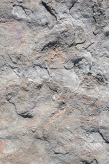 sfondo pietra superficie dura,  background, roccia con avvallamenti, foto dall'alto, terreno non regolare, colore rosso e grigio , superficie lunare