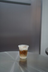 Closeup of Iced Caramel Macchiato at the coffee shop, Caramel Macchiato is a classic macchiato beverage. It consists of vanilla syrup, espresso, steamed milk, foam, and caramel drizzle