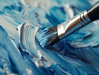 Close-up of a paintbrush on canvas creating a dynamic blue and white stroke, expressing artistic...