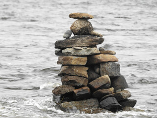 rock scuplture sitting in the river